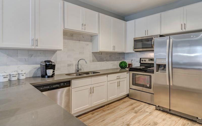 a kitchen with white cabinets