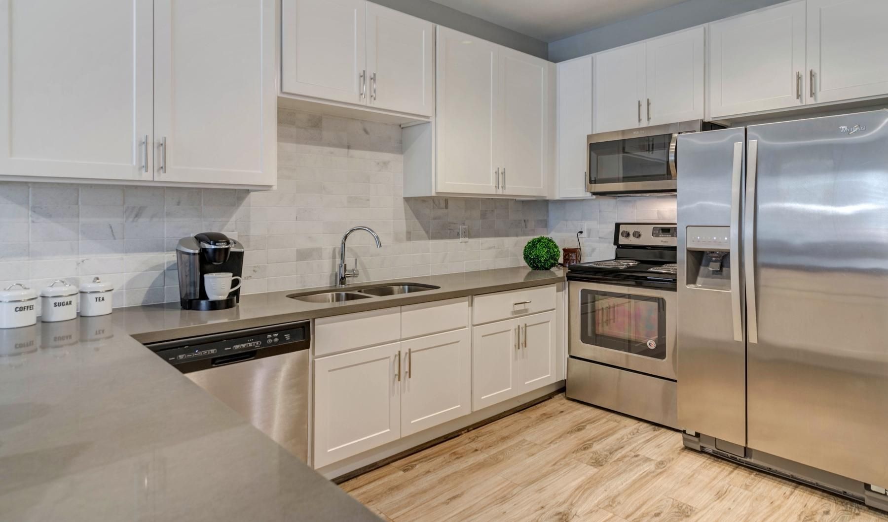 a kitchen with white cabinets